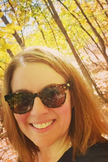 Lisa Anton headshot with forest background